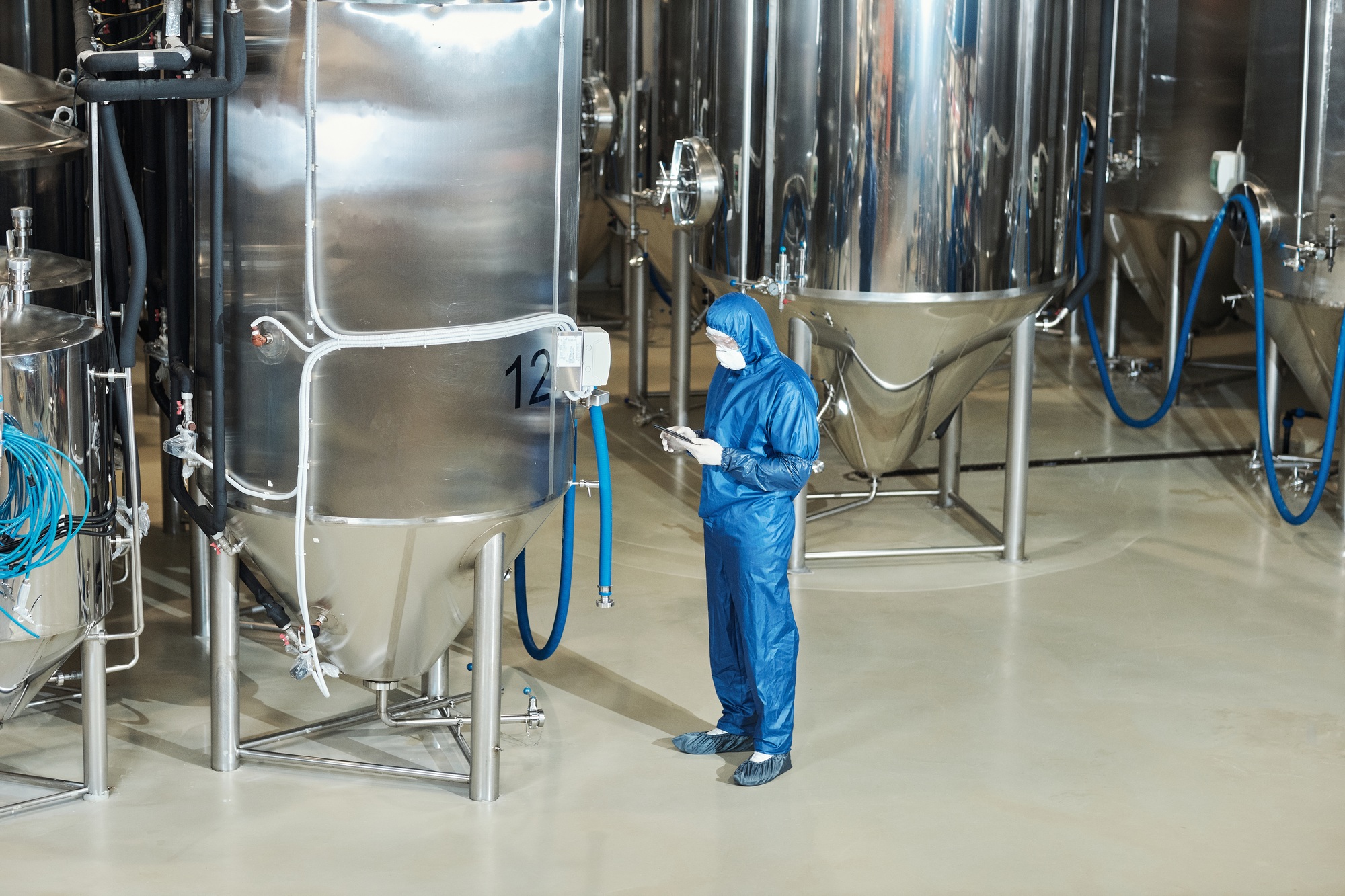 Wide angle view at factory workshop with storage tanks