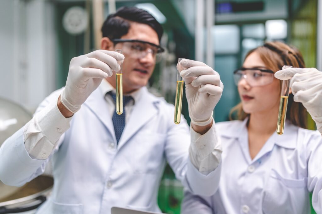 Medicine scientist working research for CBD oil from organic cannabis hemp plant in laboratory