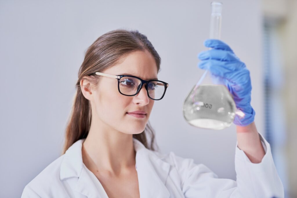 Shot of a scientist examining a beaker of liquid while standing in a laboratory