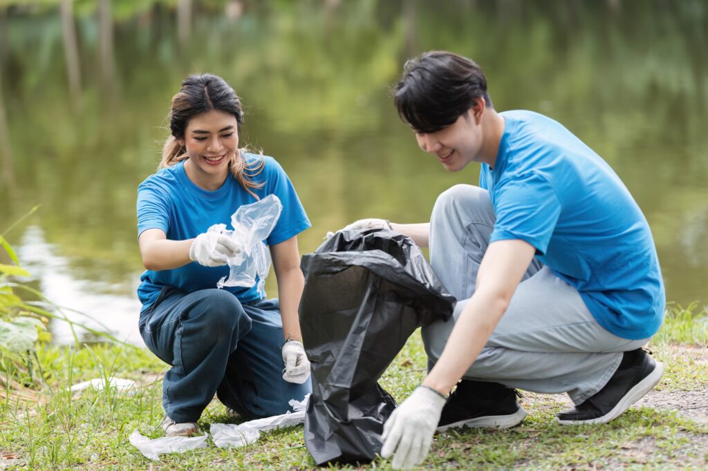 Volunteer Team Cleaning Up Nature and Caring for the Environment in a Park by a Lake